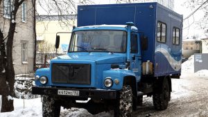 Синий грузовик компании Водоканал с кунгом на зимней улице