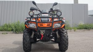 Оранжевый Stels ATV 300 на тротуаре